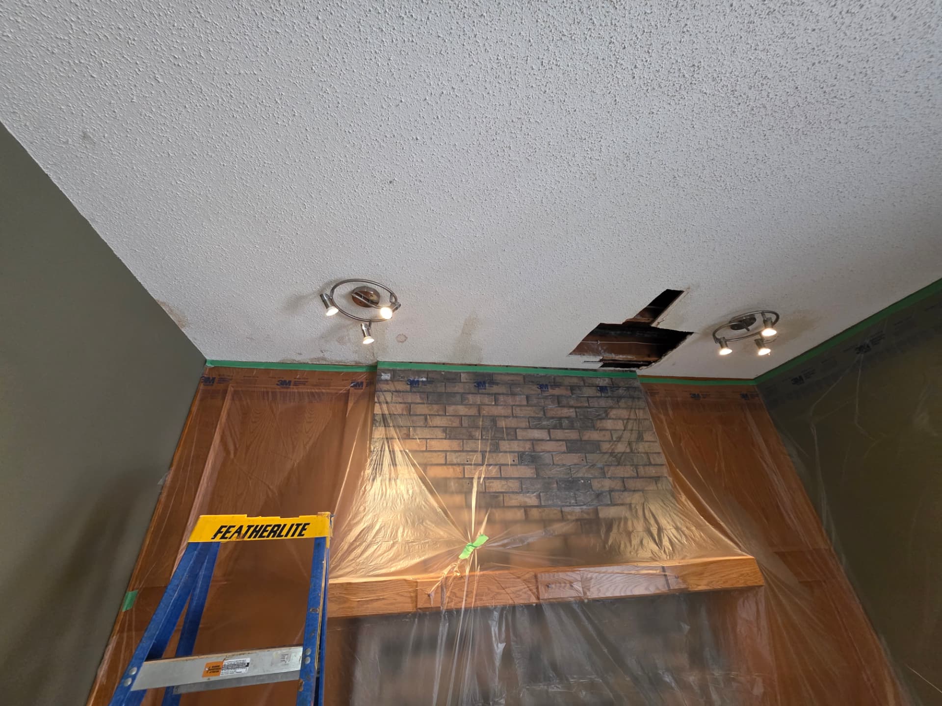 Before: close-up of the repaired ceiling area above the fireplace